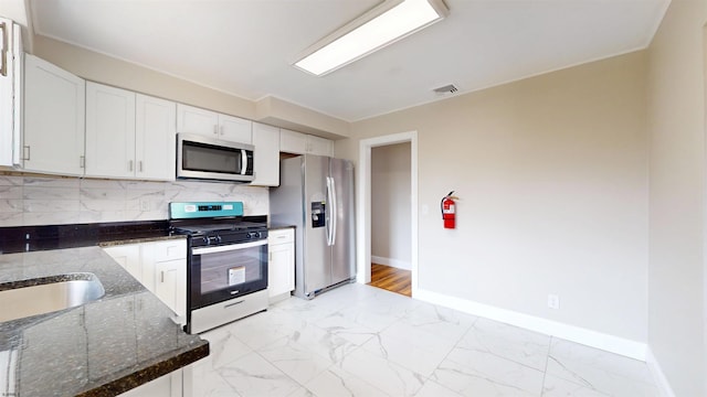 kitchen with visible vents, stainless steel appliances, decorative backsplash, white cabinets, and marble finish floor