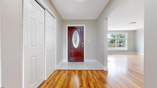 entrance foyer with baseboards and light wood-type flooring