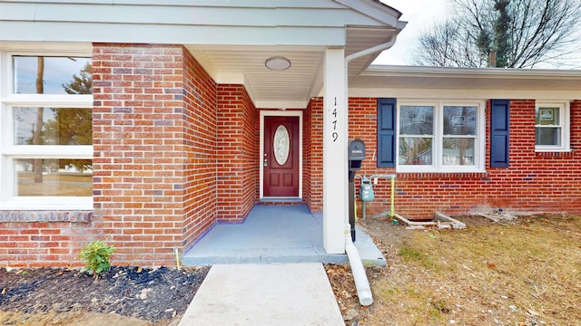 view of exterior entry with brick siding