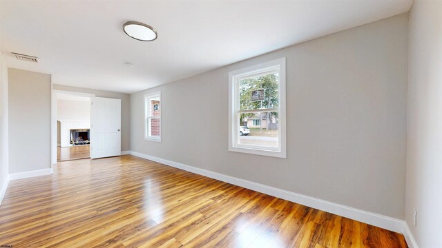 spare room featuring visible vents, baseboards, and light wood-style flooring