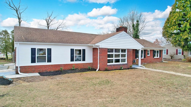 single story home with brick siding, a front lawn, roof with shingles, and a chimney