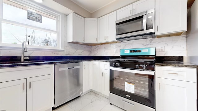 kitchen with tasteful backsplash, marble finish floor, appliances with stainless steel finishes, and a sink