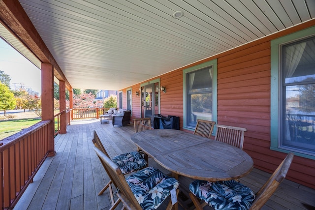 wooden terrace with outdoor dining area