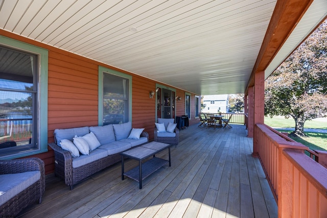 deck with outdoor lounge area and outdoor dining area