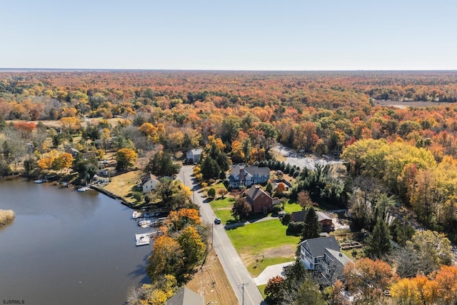 aerial view featuring a forest view and a water view