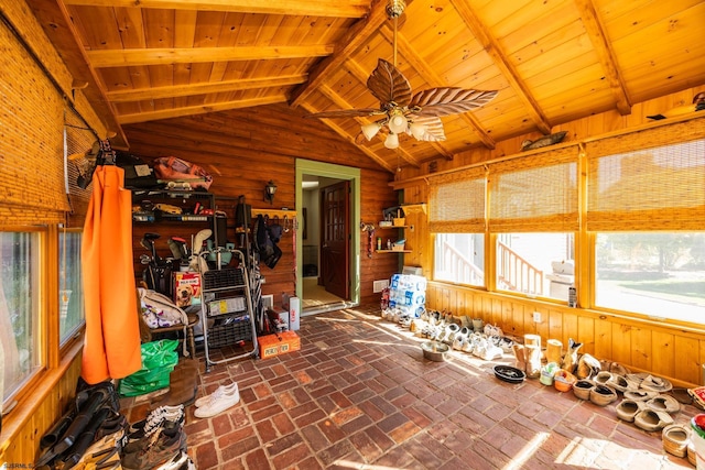 unfurnished sunroom featuring lofted ceiling with beams, wood ceiling, and a ceiling fan