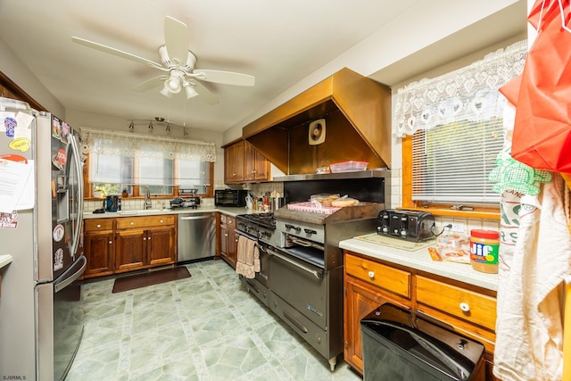 kitchen featuring ceiling fan, light countertops, light floors, and stainless steel appliances