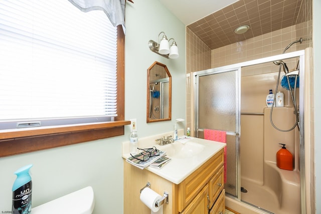 full bathroom with vanity, toilet, and a shower stall