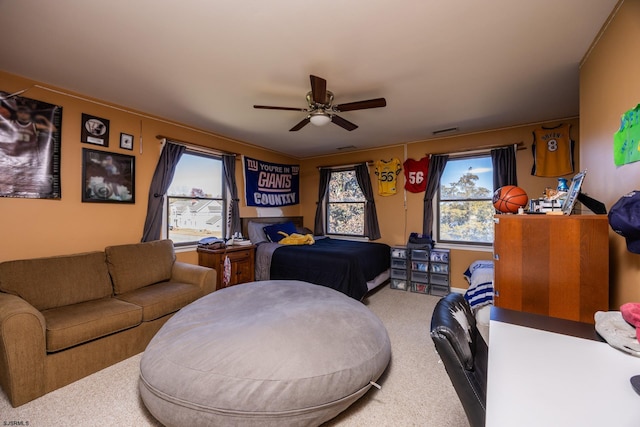 carpeted living room featuring visible vents and ceiling fan