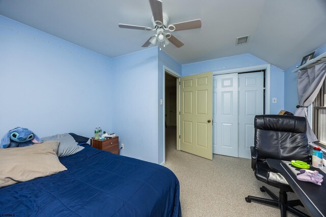 carpeted bedroom featuring visible vents, a closet, a ceiling fan, and vaulted ceiling