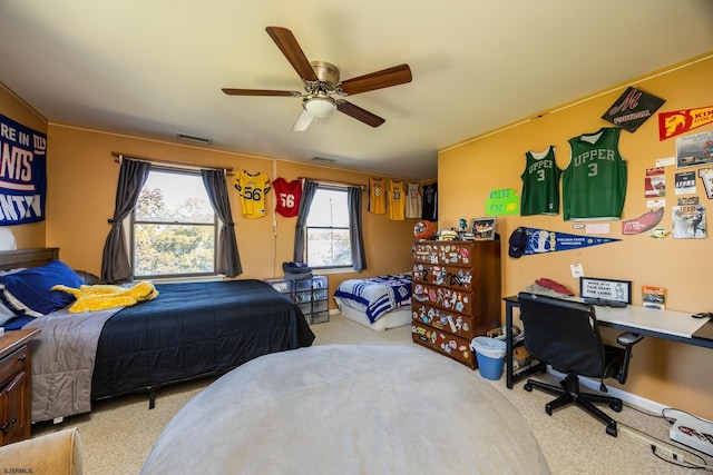 carpeted bedroom with a ceiling fan and visible vents