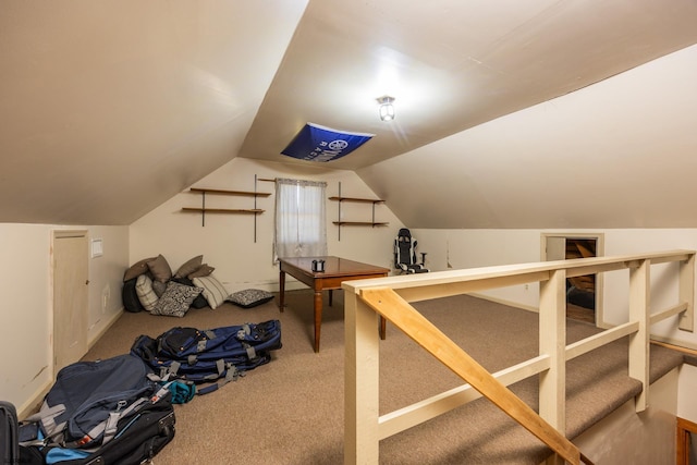 workout area with vaulted ceiling and carpet