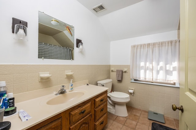 full bath featuring tile patterned flooring, visible vents, tile walls, toilet, and vanity