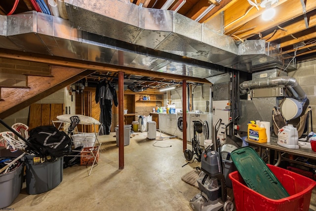 unfinished basement with stairs and separate washer and dryer