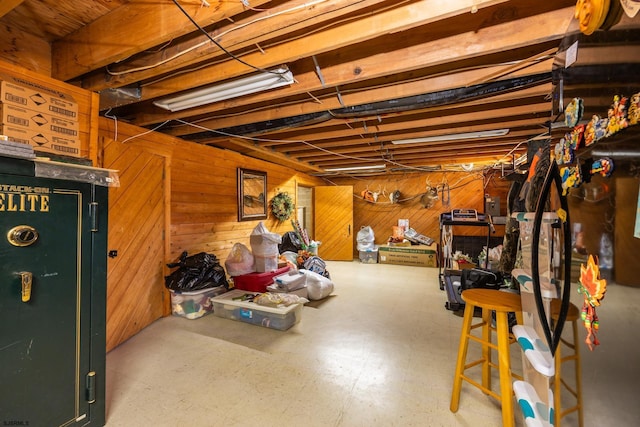 unfinished below grade area with tile patterned floors and wood walls