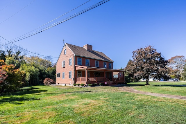 view of front of home featuring a front yard, a porch, a chimney, and roof with shingles