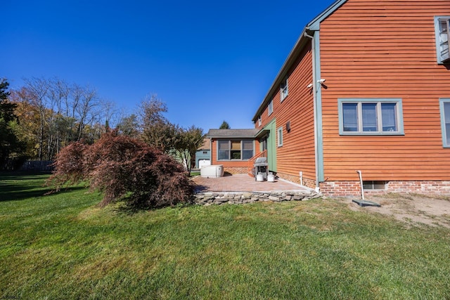 back of property with a patio and a yard