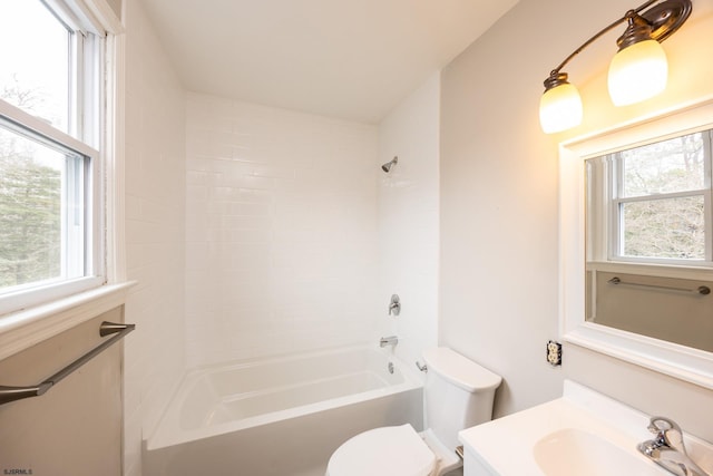 bathroom with shower / bath combination, toilet, and vanity