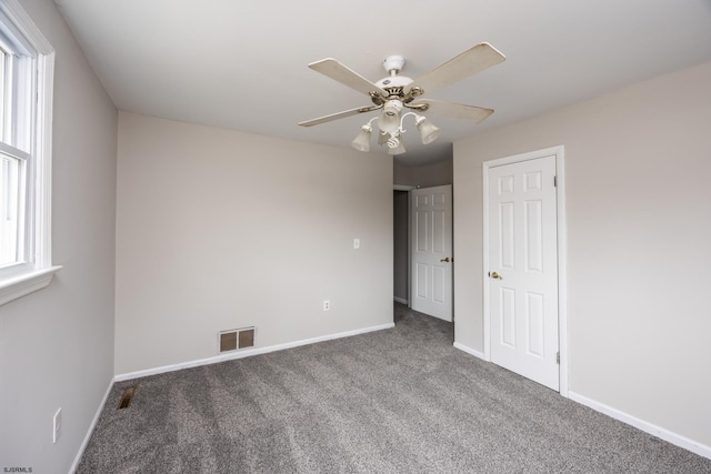 unfurnished bedroom featuring carpet flooring, baseboards, and visible vents