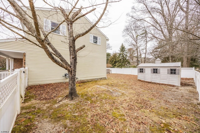 view of yard with an outdoor structure and a fenced backyard