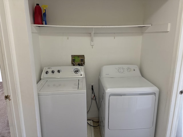 laundry area with washing machine and clothes dryer and laundry area