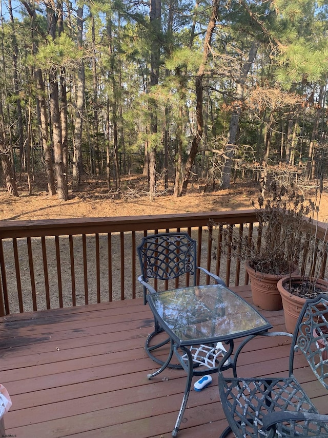 wooden terrace with outdoor dining area