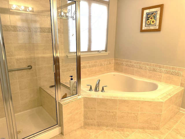 bathroom with a shower stall and a bath