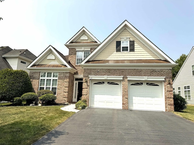 craftsman house featuring brick siding, driveway, metal roof, and a standing seam roof