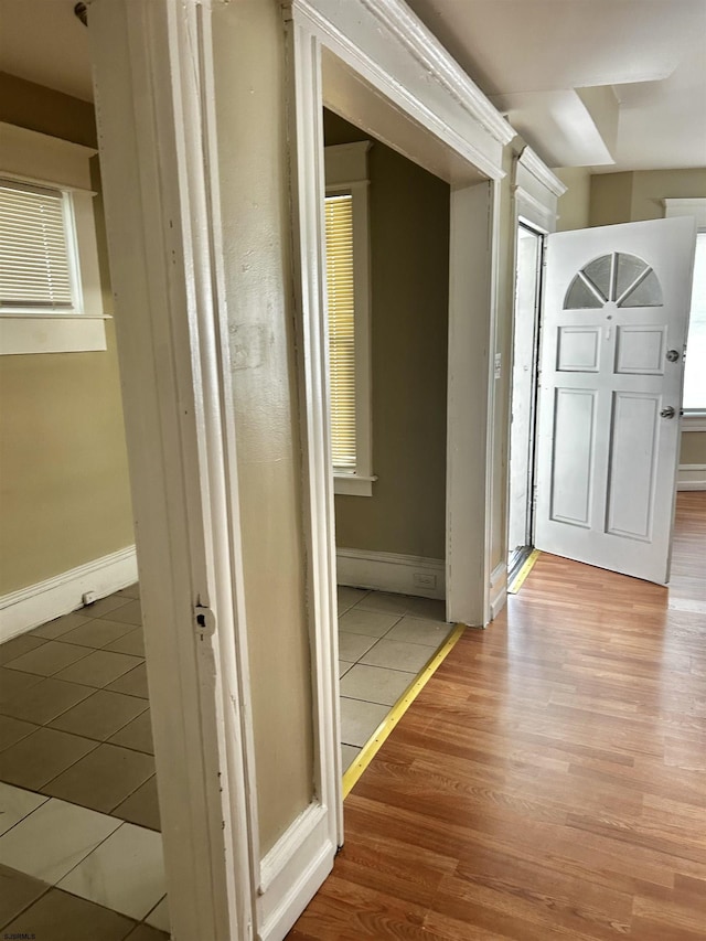 hall with wood finished floors and baseboards