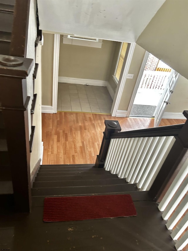 stairs with baseboards and wood finished floors