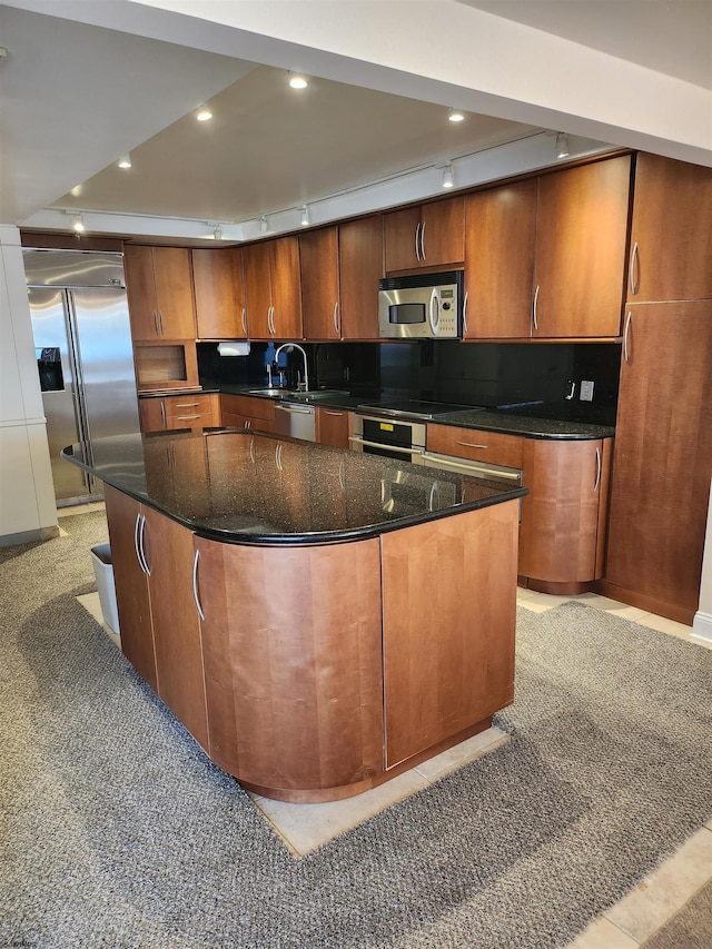 kitchen featuring a center island, light colored carpet, dark stone counters, recessed lighting, and stainless steel appliances