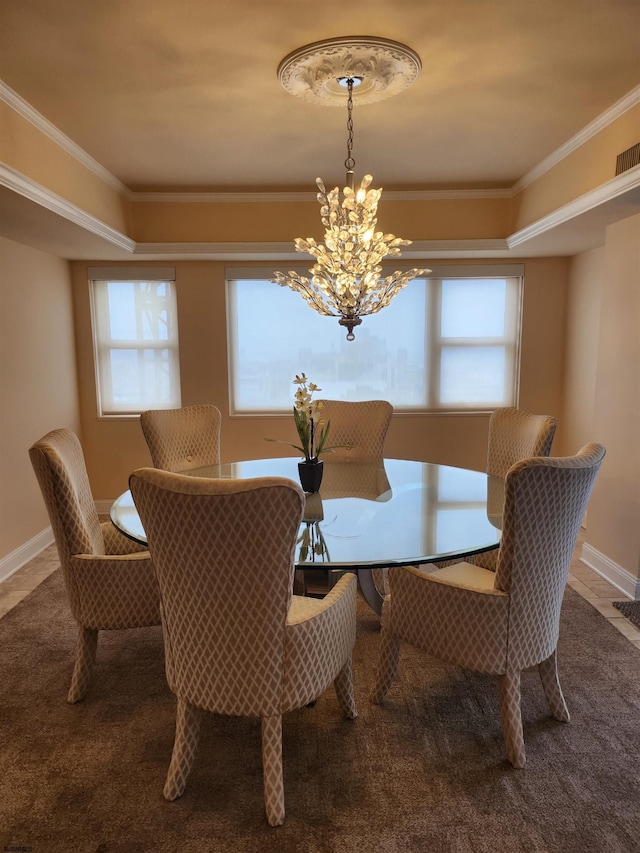 tiled dining room with a notable chandelier, baseboards, and ornamental molding