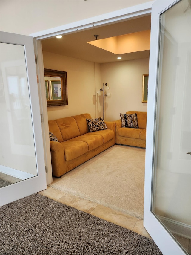 carpeted living area with tile patterned flooring