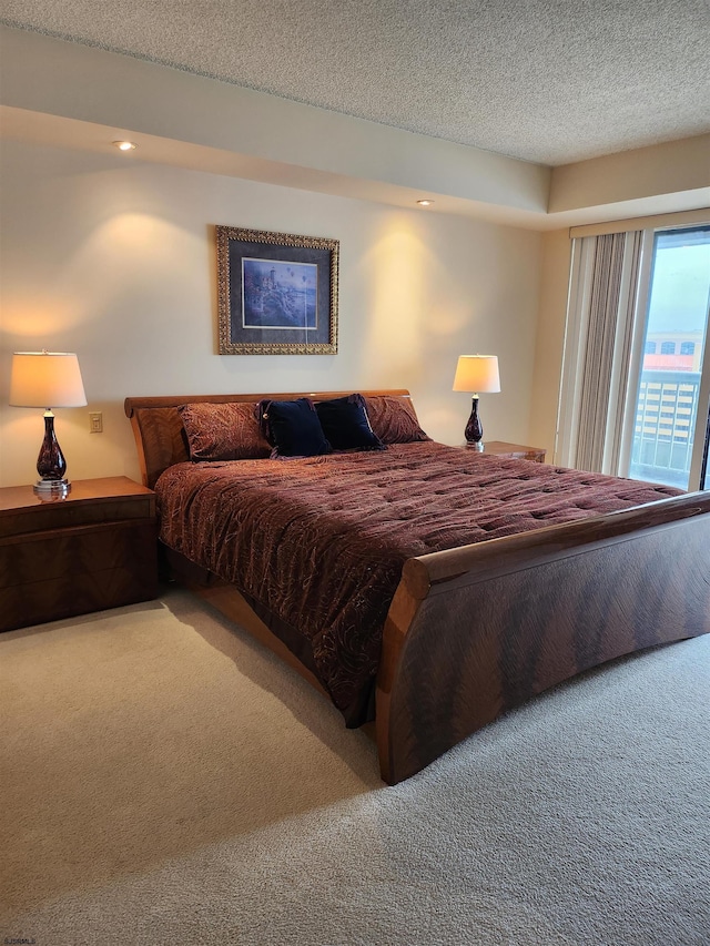 bedroom with recessed lighting, carpet floors, and a textured ceiling