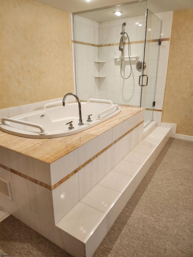 full bath with a tile shower and a garden tub