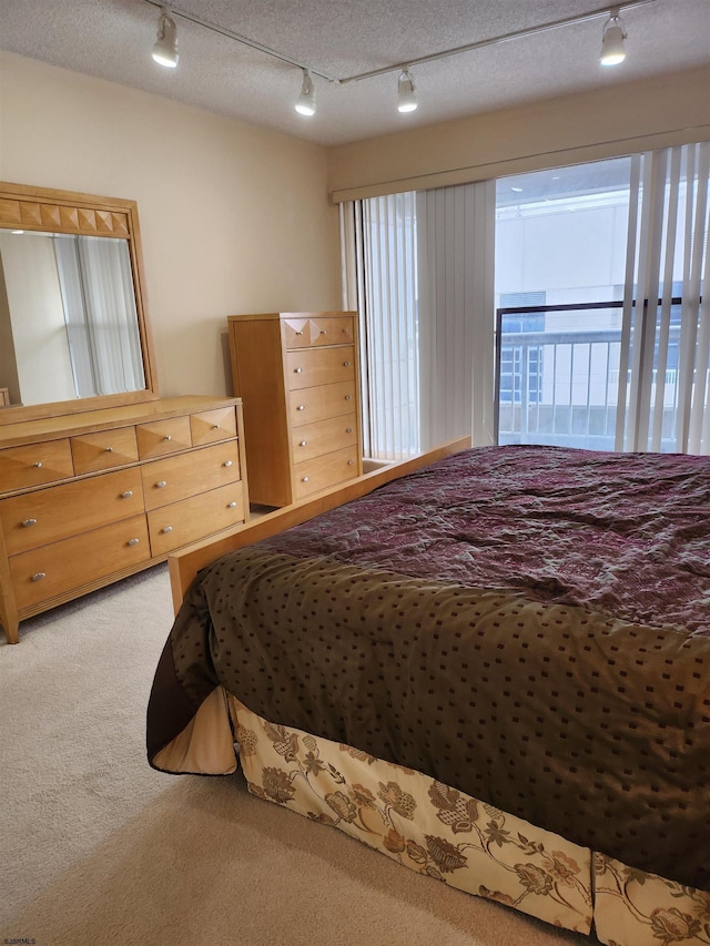 bedroom with light carpet and a textured ceiling