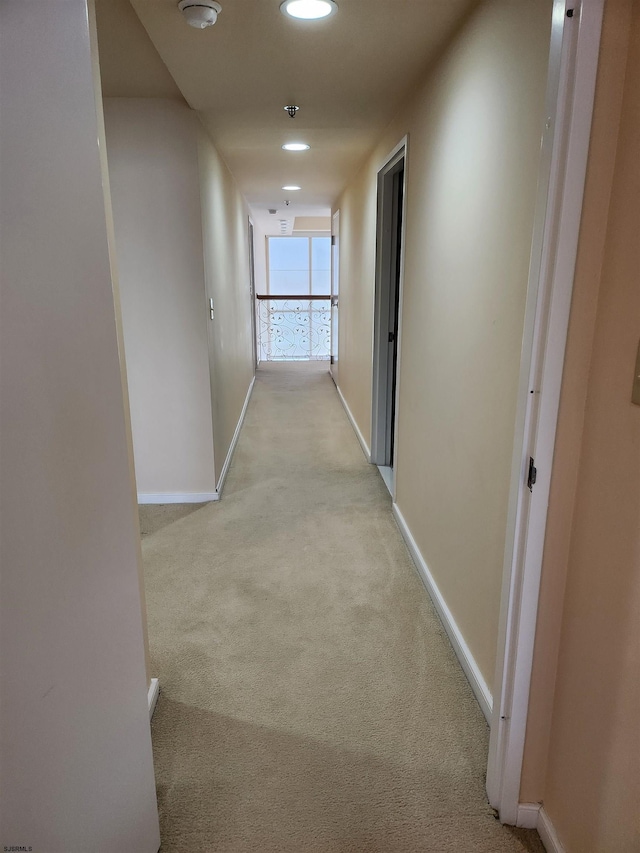 hall with recessed lighting, baseboards, and light carpet