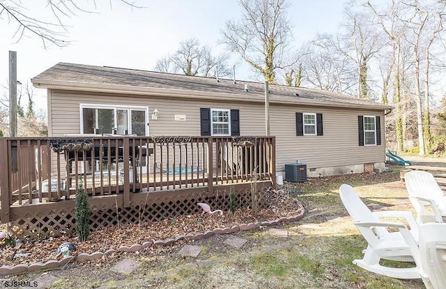 back of property featuring crawl space, central AC, and a deck