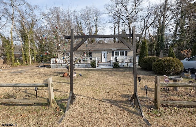 view of front of home featuring a deck and fence