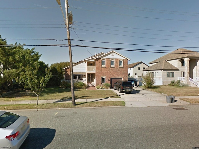 602 N Dorset Ave, Ventnor, NJ 08406 - view of front of home featuring concrete driveway, a residential view, a front yard, brick siding, and a garage