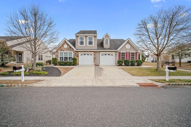 view of front of house featuring a garage, stone siding, and driveway