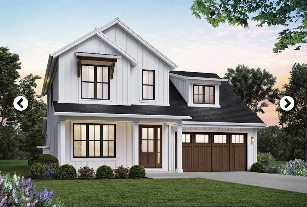 modern farmhouse with a front lawn, board and batten siding, and driveway