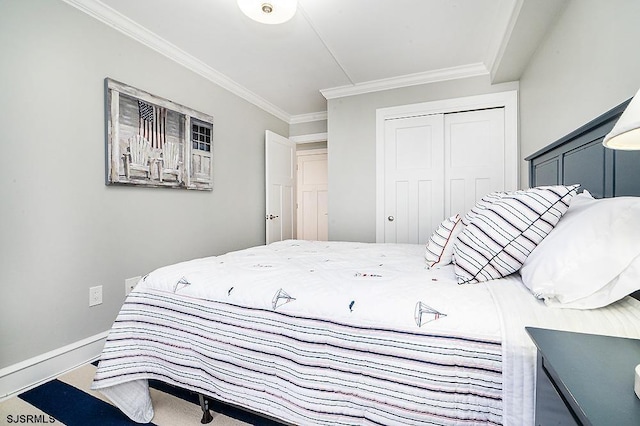 bedroom with a closet, crown molding, and baseboards