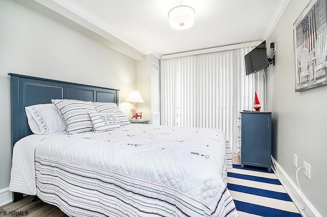 bedroom with baseboards and ornamental molding