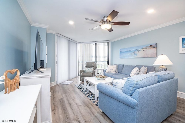 living area with baseboards, recessed lighting, ornamental molding, ceiling fan, and light wood-type flooring