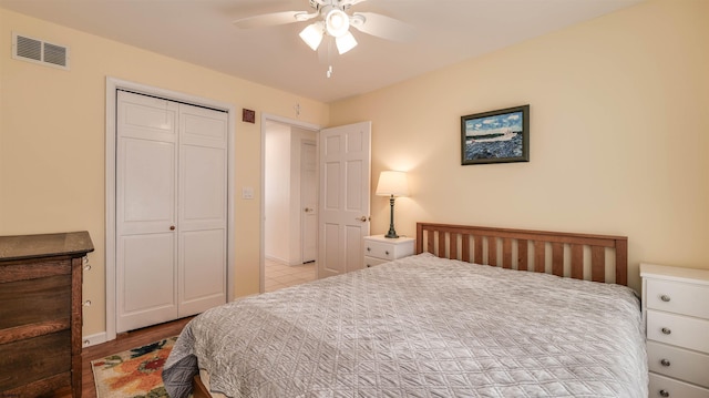 bedroom featuring visible vents, wood finished floors, a closet, and ceiling fan