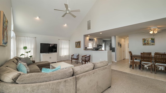 living area featuring light colored carpet, light tile patterned floors, a ceiling fan, and visible vents