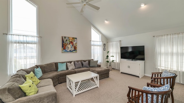 living area featuring high vaulted ceiling, light colored carpet, and ceiling fan