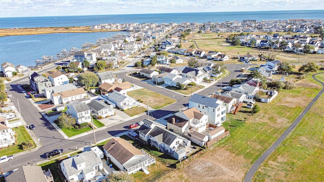 drone / aerial view with a residential view and a water view