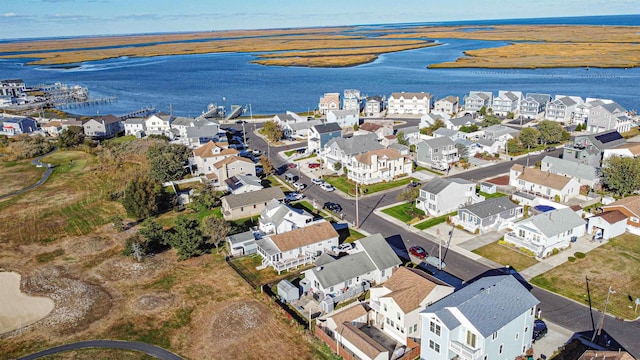 drone / aerial view with a water view and a residential view